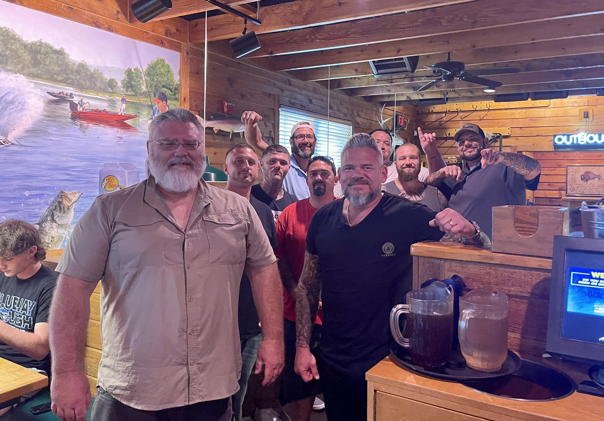 Executive Director and staff connecting over BBQ with graduates and residents of Straight Street
