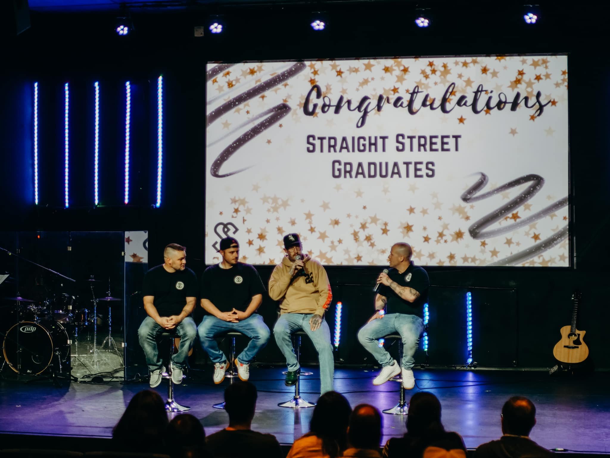 Graduates sharing their positive recovery experiences at a local church service for their graduation ceremony.